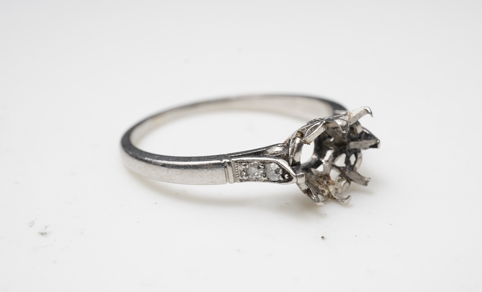 A platinum and diamond ring mount, France, early 20th century